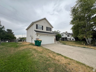 View of front of home with a garage and driveway