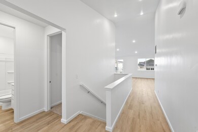 Corridor with an upstairs landing, recessed lighting, and light wood-type flooring