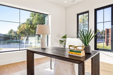 Office space featuring light wood-style flooring and recessed lighting