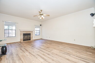 Spacious family room with fireplace and views of t