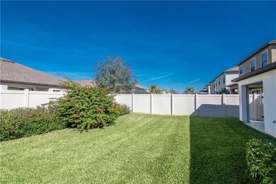 Rear covered porch with spacious fenced yard