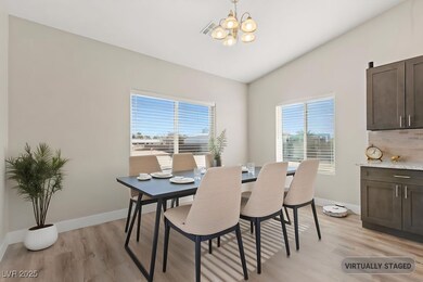 Dining area featuring an inviting chandelier, vaul