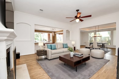 The expansive living room is
designed for comfort and style.
With beautiful hardwood floors, a
ceiling fan, and built-in shelving,
this room is perfect for relaxing or
entertaining. The large windows
flood the space with natural light,
creating a warm and inviting
atmosphere. Adjacent to the dining
area, it offers a seamless flow
throughout the main living spaces.