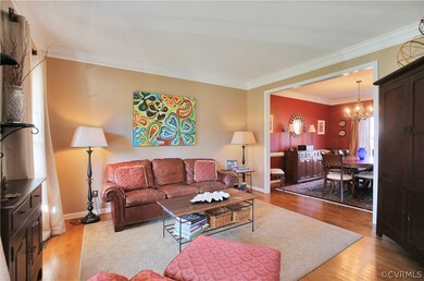 Formal living room with crown molding and wonderful natural light.
