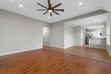 Unfurnished living room featuring ceiling fan with