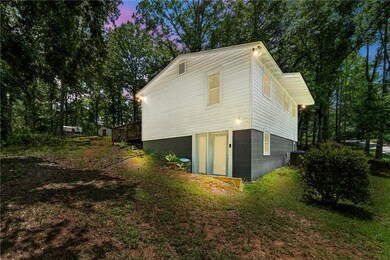 Property exterior at dusk with a central AC unit and a wooden deck