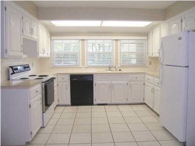 The fully applianced pristine white kitchen is bat