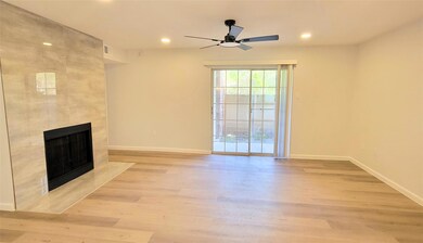 Living area overlooking covered patio and side yar