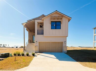 View of front of house featuring a garage and a front yard