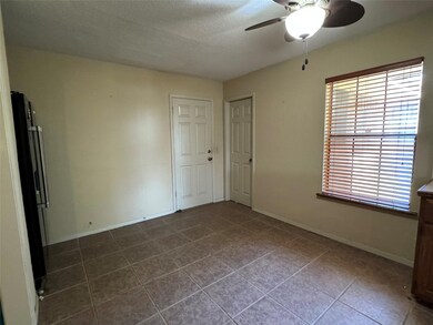 Tiled breakfast area featuring ceiling fan and a t
