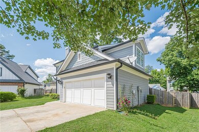 View of property exterior with a garage and a chim