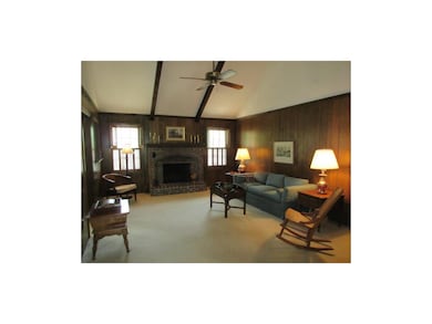Spacious great room has vaulted ceilings and a woo