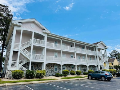 View of property featuring uncovered parking and s