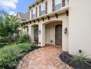 walkway to front of home featuring a large covered