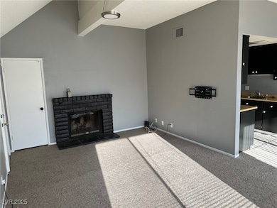 Unfurnished living room with carpet, a fireplace,