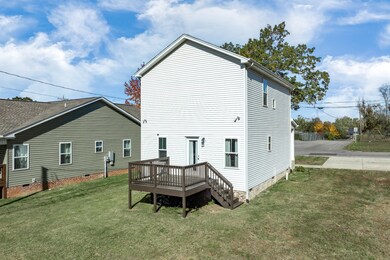 Back view of the house showing the spacious yard & deck for entertaining