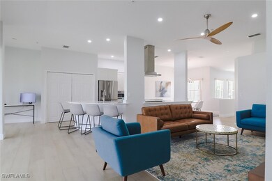 Living room featuring ceiling fan and light wood-t