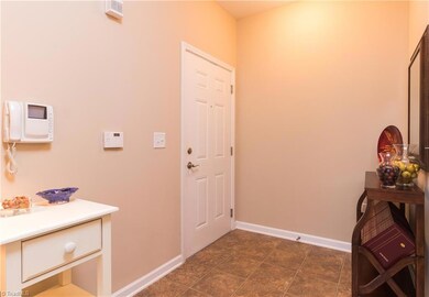 Foyer/Entrance of unit 1B. Vinyl floor covering for easy cleaning. The phone seen on the wall is what allows you to speak with your visitors at the front door.