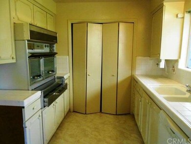 Kitchen has a laundry area and electric appliances