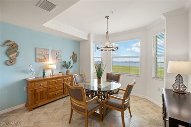 Dining area with baseboards, crown molding, an inv