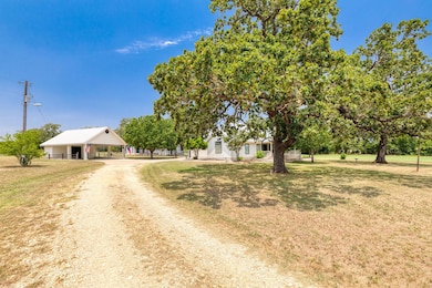 View of front of home featuring dirt driveway, a 