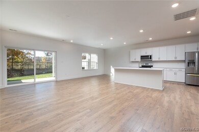 Kitchen with white cabinetry, light wood-type floo