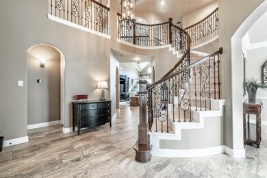 Step inside this impressive home and enjoy distinctive lines, curved arches, and dramatic finishes. To the right of the entry is a study. To the left is a guest room with full bath.