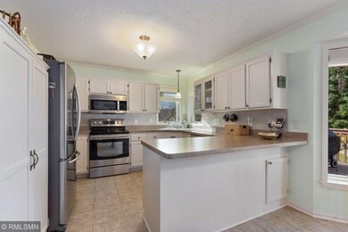 White kitchen with stainless appliances