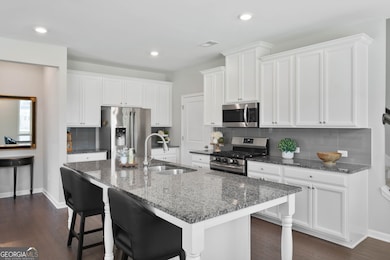 Center island with granite counters, stainless appliances and walk in pantry