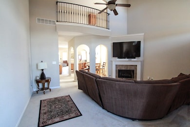 Living room with carpet, visible vents, a tiled fi