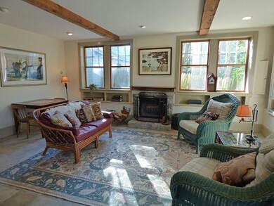 Light filled living room with fireplace.