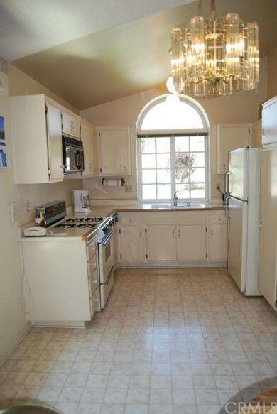 Kitchen is located in the front of the home lookin