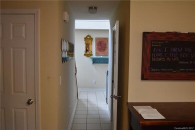 pantry door and hall with 1/2 bath downstairs and 