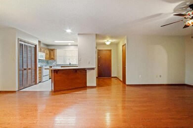 Unfurnished living room featuring ceiling fan and light hardwood / wood-style flooring