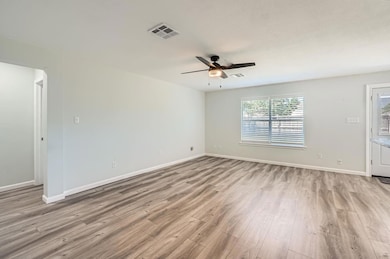 Empty room with wood finished floors and ceiling 