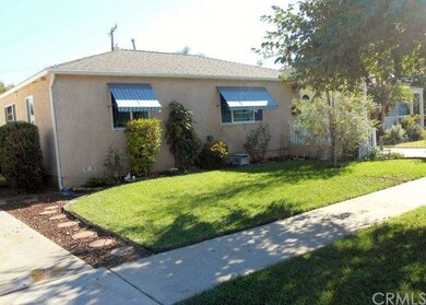 Very Manicured Front Lawn with Sprinklers. 