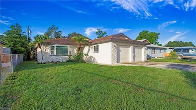 Single story home featuring stone siding, an attached garage, stucco siding, and concrete driveway