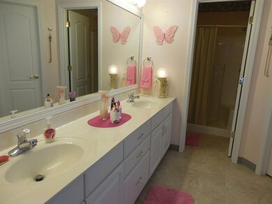Master bath has double sinks, a spa tub and  separ