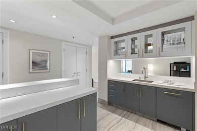 Kitchen with glass insert cabinets, light countert