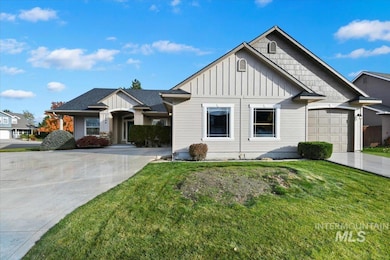 Craftsman-style home with board and batten siding, concrete driveway, and a front yard