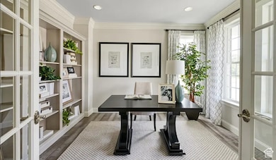 Office area featuring french doors, dark wood-style floors, ornamental molding, and recessed lighting