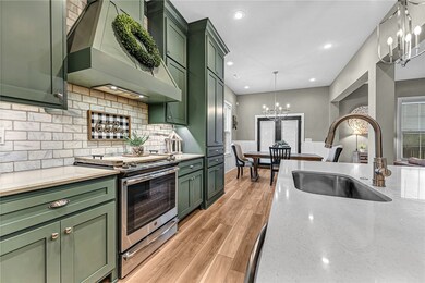 Stainless steel appliances and gorgeous newly painted cabinets.