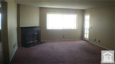 Living room view with fireplace and balcony entran