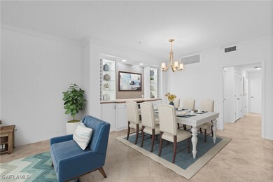 Dining area featuring ornamental molding, a chande
