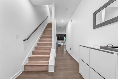 Stairway with wood finished floors, recessed lighting, and baseboards