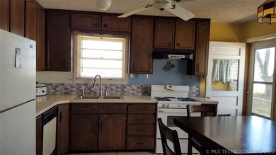 The eat-in kitchen has newer neutral tile along th
