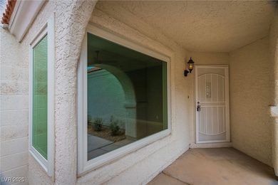 Entrance to property featuring stucco siding