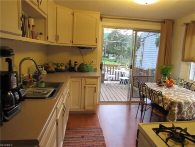 Neutral kitchen with slider to the rear deck that 