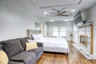 Bedroom with beam ceiling, a fireplace, recessed l