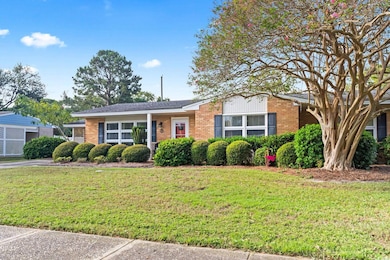 Single story home featuring a front lawn